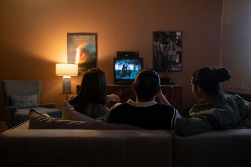 Best Canadian Entertainment Platforms: Friends Sitting Together on a Couch in front of a TV