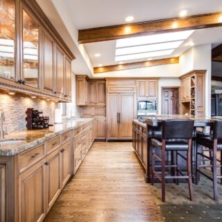 Hardwood: Large kitchen with wooden floors and cabinets