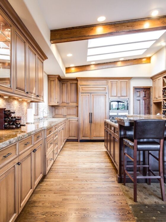 Hardwood: Large kitchen with wooden floors and cabinets