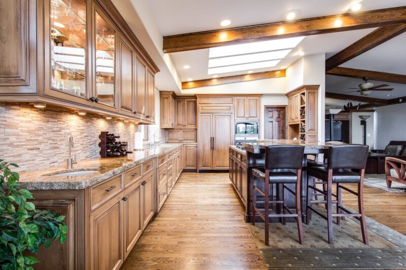 Hardwood: Large kitchen with wooden floors and cabinets