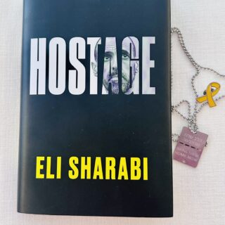 Hostage by Eli Sharabi: Book with hostage tag and hostage pin next to it