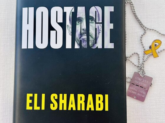 Hostage by Eli Sharabi: Book with hostage tag and hostage pin next to it
