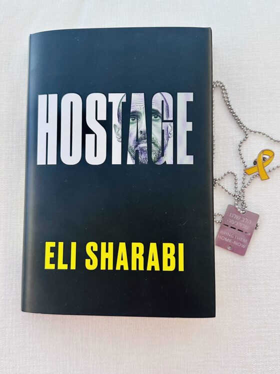 Hostage by Eli Sharabi: Book with hostage tag and hostage pin next to it