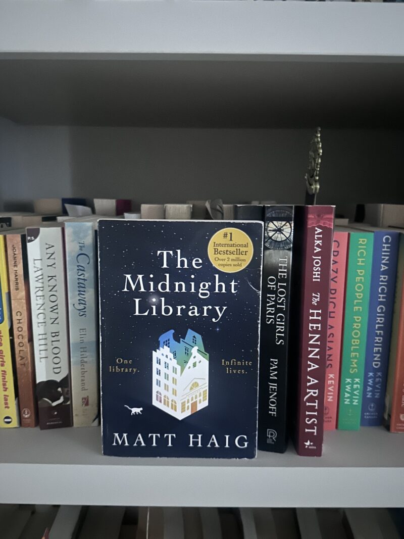 The Midnight Library: Book on a shelf with other books