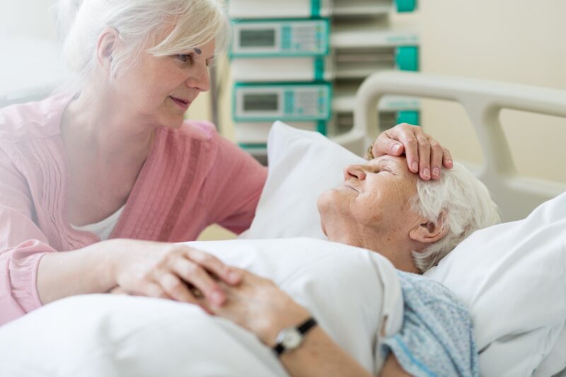 Palliative Care: Daughter visiting her senior mother in hospital
