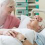Palliative Care: Daughter visiting her senior mother in hospital