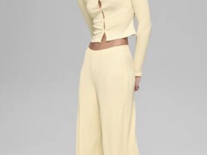 Alo Yoga Drop: Woman in wide yellow yoga pants and a cropped yellow top