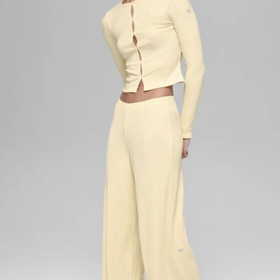 Alo Yoga Drop: Woman in wide yellow yoga pants and a cropped yellow top