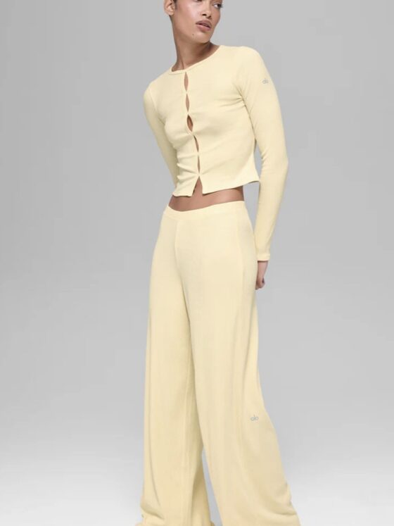 Alo Yoga Drop: Woman in wide yellow yoga pants and a cropped yellow top