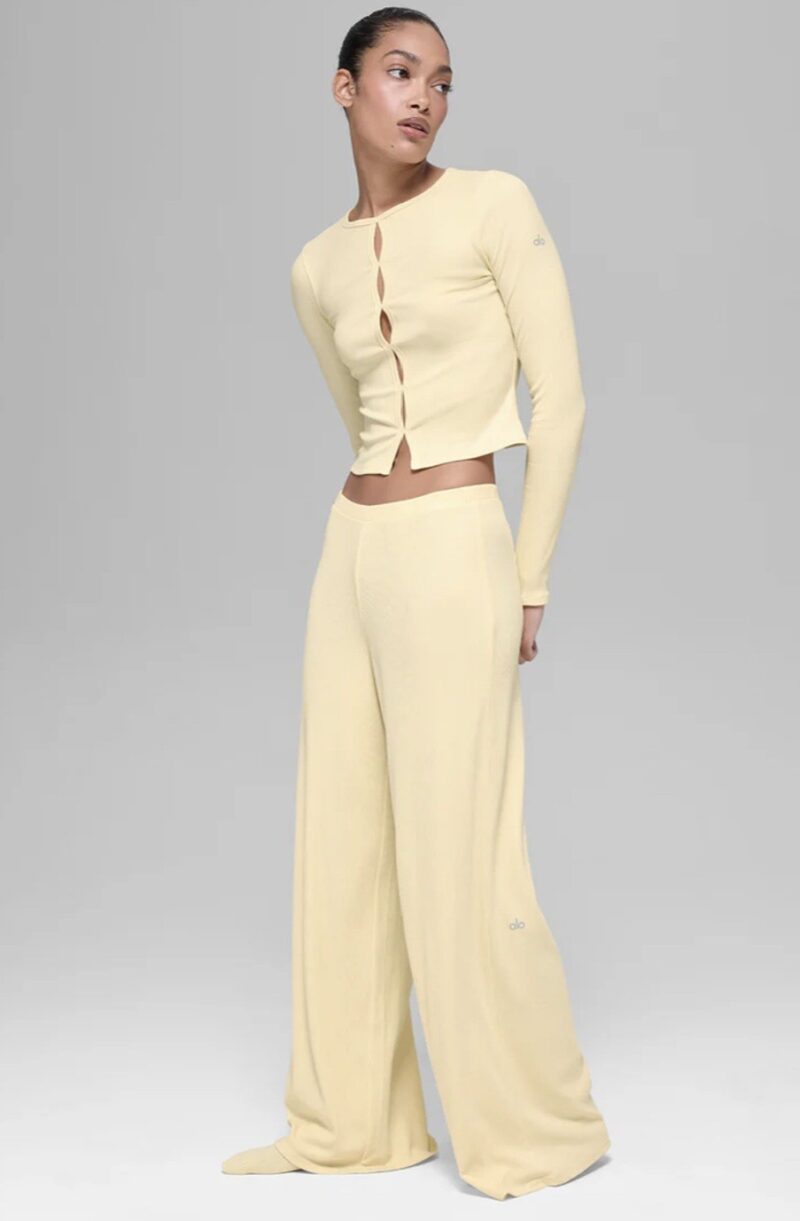 Alo Yoga Drop: Woman in wide yellow yoga pants and a cropped yellow top