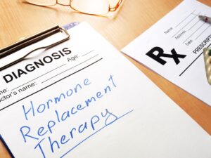 HRT: Clipboard with medical form and sign Hormone Replacement Therapy.