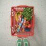 Protein for Women: Grocery basket with produce and Mighty Protein sticks next to women's sneakers