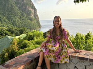 Beyond the Resort: Natalie sitting on an overhang near the water