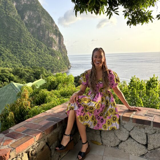 Beyond the Resort: Natalie sitting on an overhang near the water