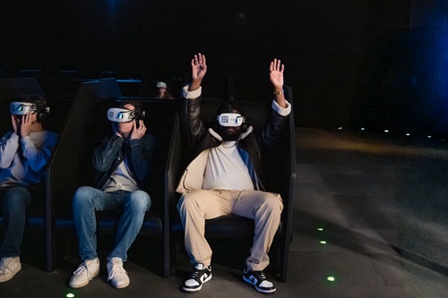 Space Explorers: THE INFINITE: People seated with VR goggles on 