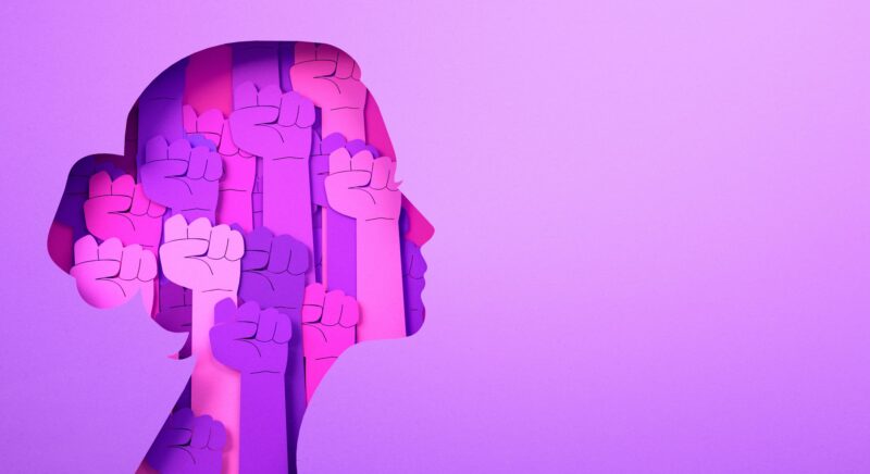 International Women's Day 2026: Pink graphic of a woman's head filled with rising fists.