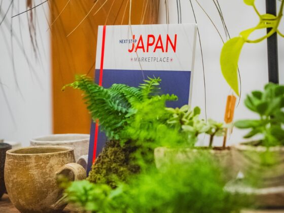 Japanese: Sign for Japan Marketplace surrounding by plants and pottery