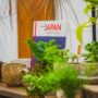 Japanese: Sign for Japan Marketplace surrounding by plants and pottery