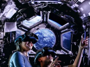 Space Explorers: The Infinite: Woman and Child with Space in the background wearing VR goggles