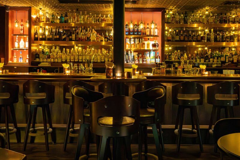 Speakeasy: Dark, moody bar with bar stools