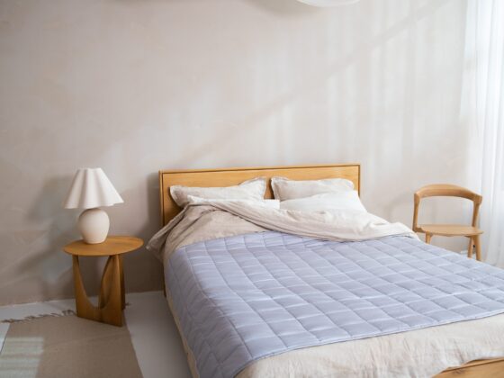 Duvet Cover: Bed with duvet cover on plus small table with lamp and chair
