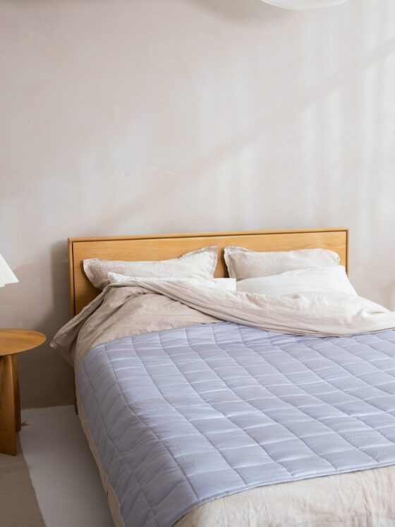 Duvet Cover: Bed with duvet cover on plus small table with lamp and chair