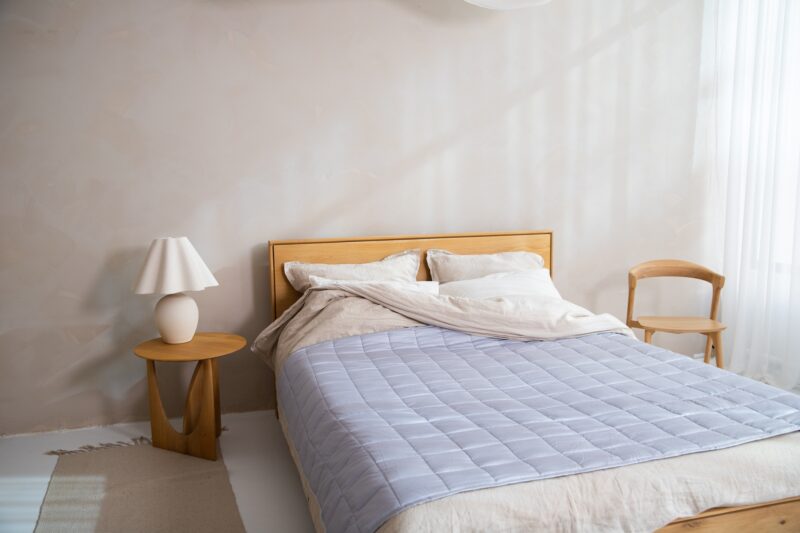 Duvet Cover: Bed with duvet cover on plus small table with lamp and chair