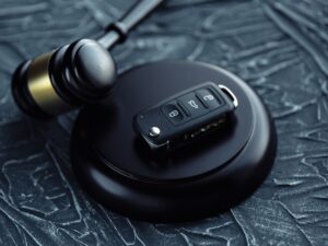 Day in Court: Car auction concept - gavel and car key on the wooden desk