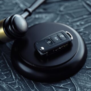 Day in Court: Car auction concept - gavel and car key on the wooden desk