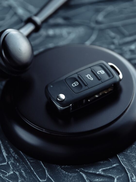 Day in Court: Car auction concept - gavel and car key on the wooden desk