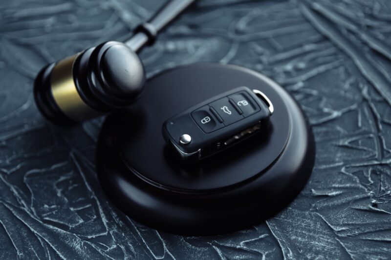 Day in Court: Car auction concept - gavel and car key on the wooden desk
