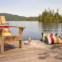 Hudson’s Bay Stripes Collection: Muskoka Chair with pillows and drinks on a tray near a lake