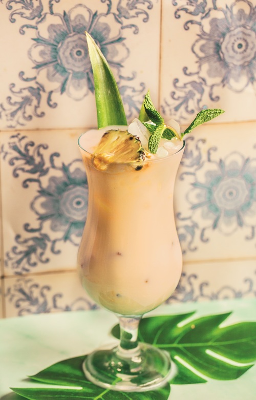 Beach Cocktail: Creamy cocktail topped with pineapple in a pina colada glass