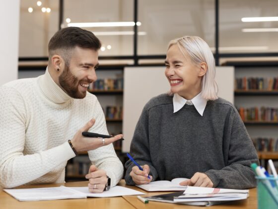 Tutors in Toronto: Two friends laughing as they are studying together
