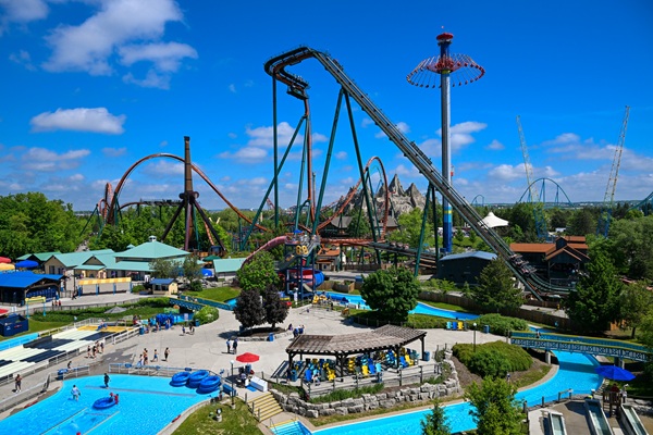 Canada's Wonderland: Splashworks park with lazy river in the foreground and slide and thrill ride in the background