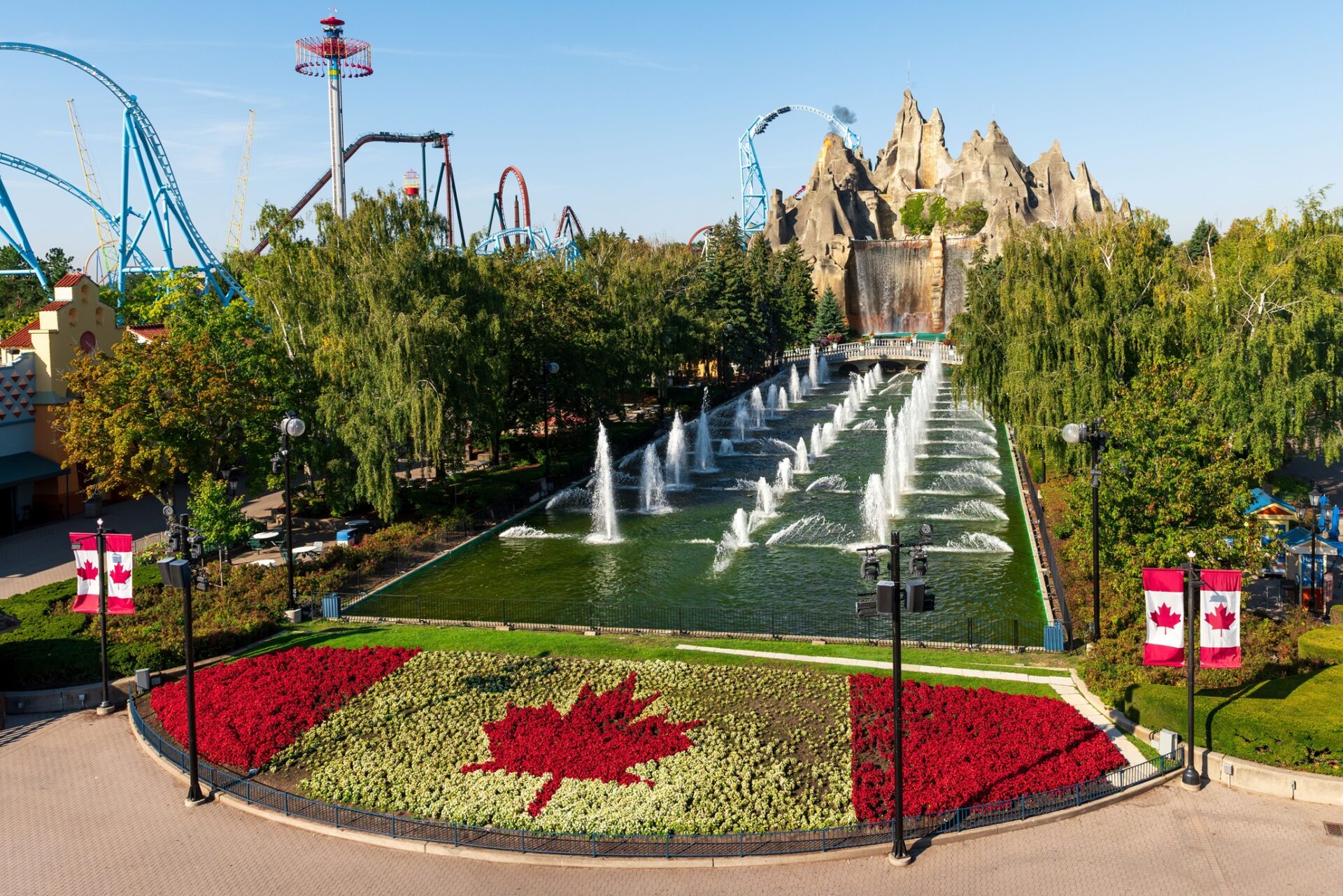 Canada's Wonderland: Wonder Mountain with topiary Canadian flag in the foreground and roller coasters in the background