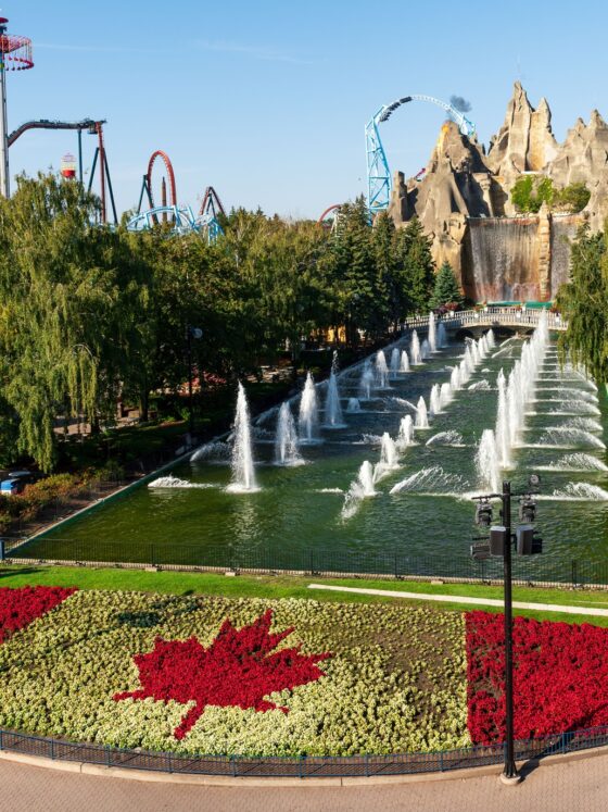 Canada's Wonderland: Wonder Mountain with topiary Canadian flag in the foreground and roller coasters in the background