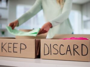 Decluttering: Organized Woman Sorting Through Wardrobe, Decluttering Clothes For Donation