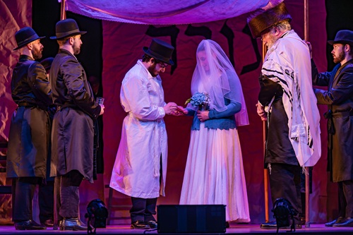 Fiddler On The Roof In Yiddish: Couple from the play getting married under a chuppah (canopy)
