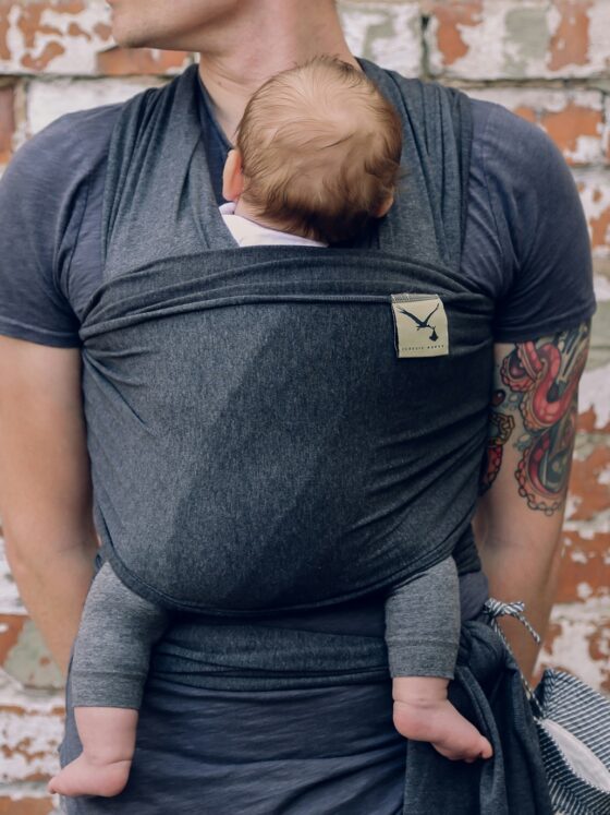 New Parent: Father holding newborn baby in a sling
