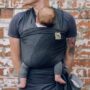 New Parent: Father holding newborn baby in a sling