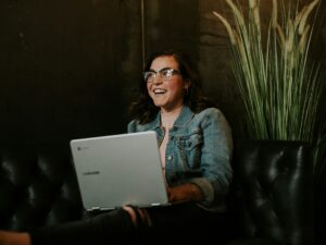 Online Payment: Woman smiling while holding a laptop