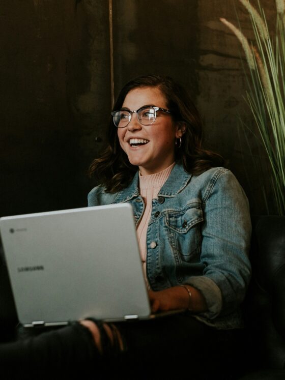 Online Payment: Woman smiling while holding a laptop