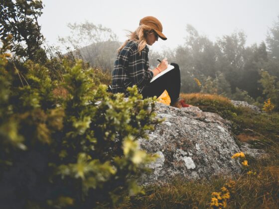 Paper Journaling: Woman in nature writing in a journal