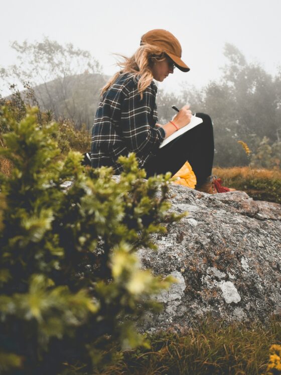 Paper Journaling: Woman in nature writing in a journal