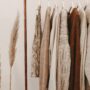 Minimalist Fall Wardrobes: Tops and sweaters hanging on a clothing rack