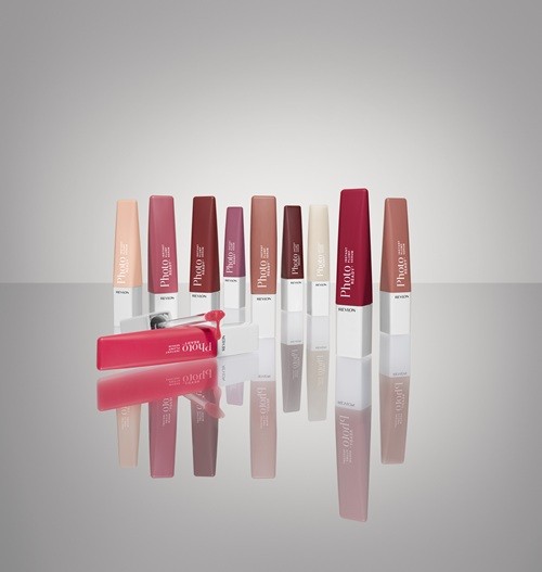 Lip Product: Revlon PhotoReady™ Instant Plump Serum - 8 units are closed - one is on it's side open with the lipgloss wand next to it