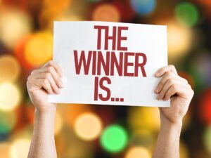 Win Things: The Winner Is... placard with bokeh background
