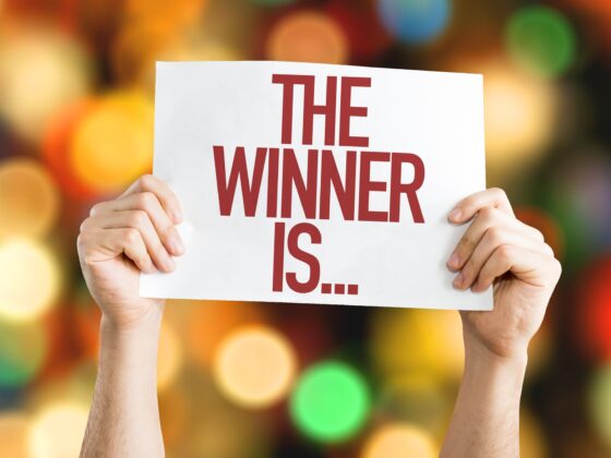 Win Things: The Winner Is... placard with bokeh background
