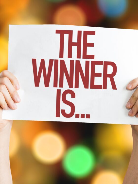 Win Things: The Winner Is... placard with bokeh background